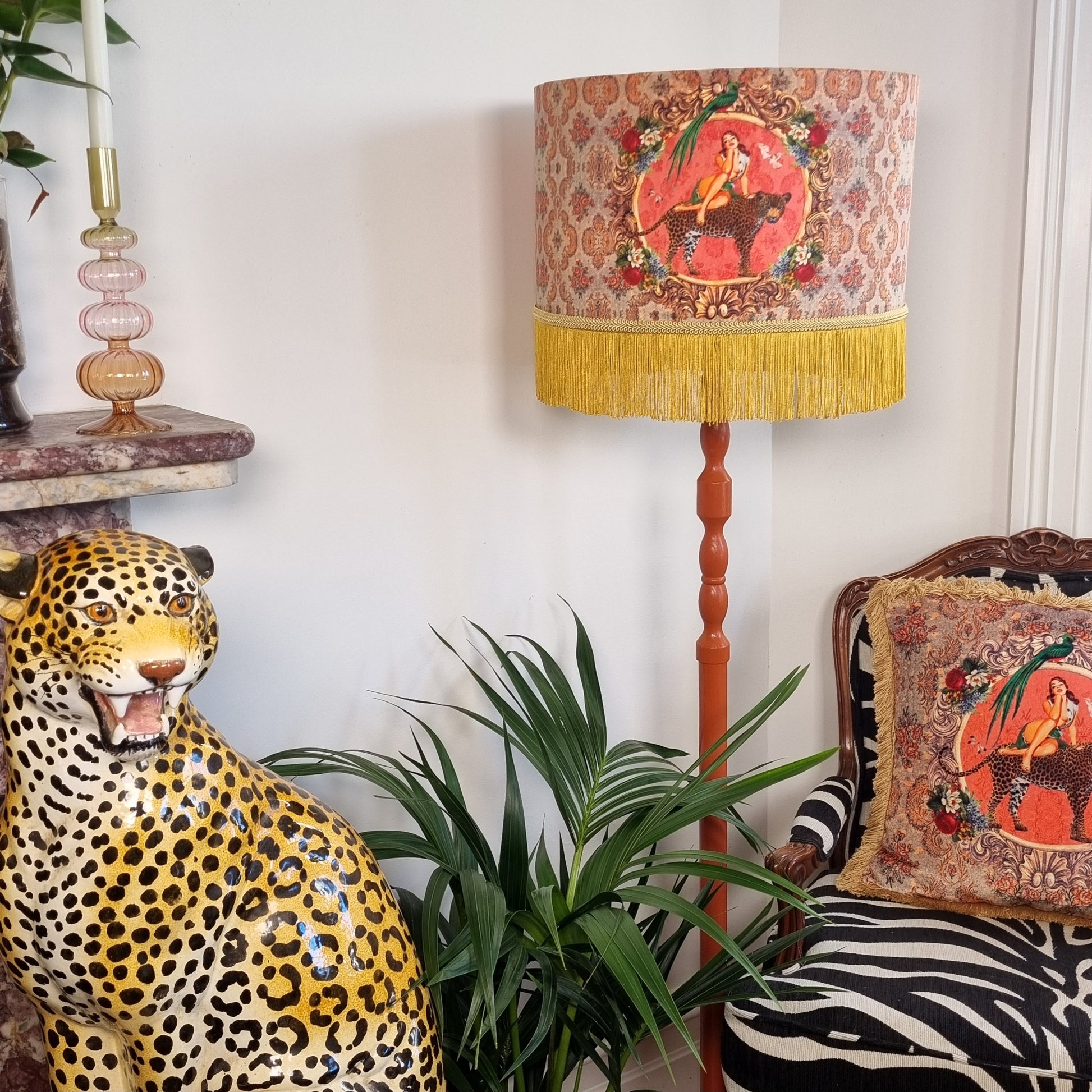 Alice Vintage Tassel Drum Lamp shade with fringed yellow tassels on a wooden lamp base in a decorated living room