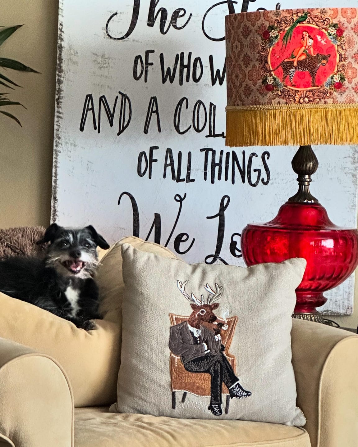 Alice Vintage Tassel Drum Lamp shade by Queen K in red with fringe on a table next to a couch with pillows and a dog