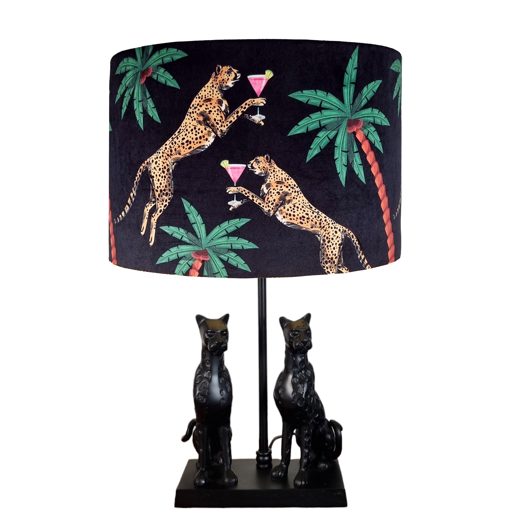 Queen K Cocktail Cheetah Drum Lampshade Black with palm tree print on a black lamp base with two cheetah figures