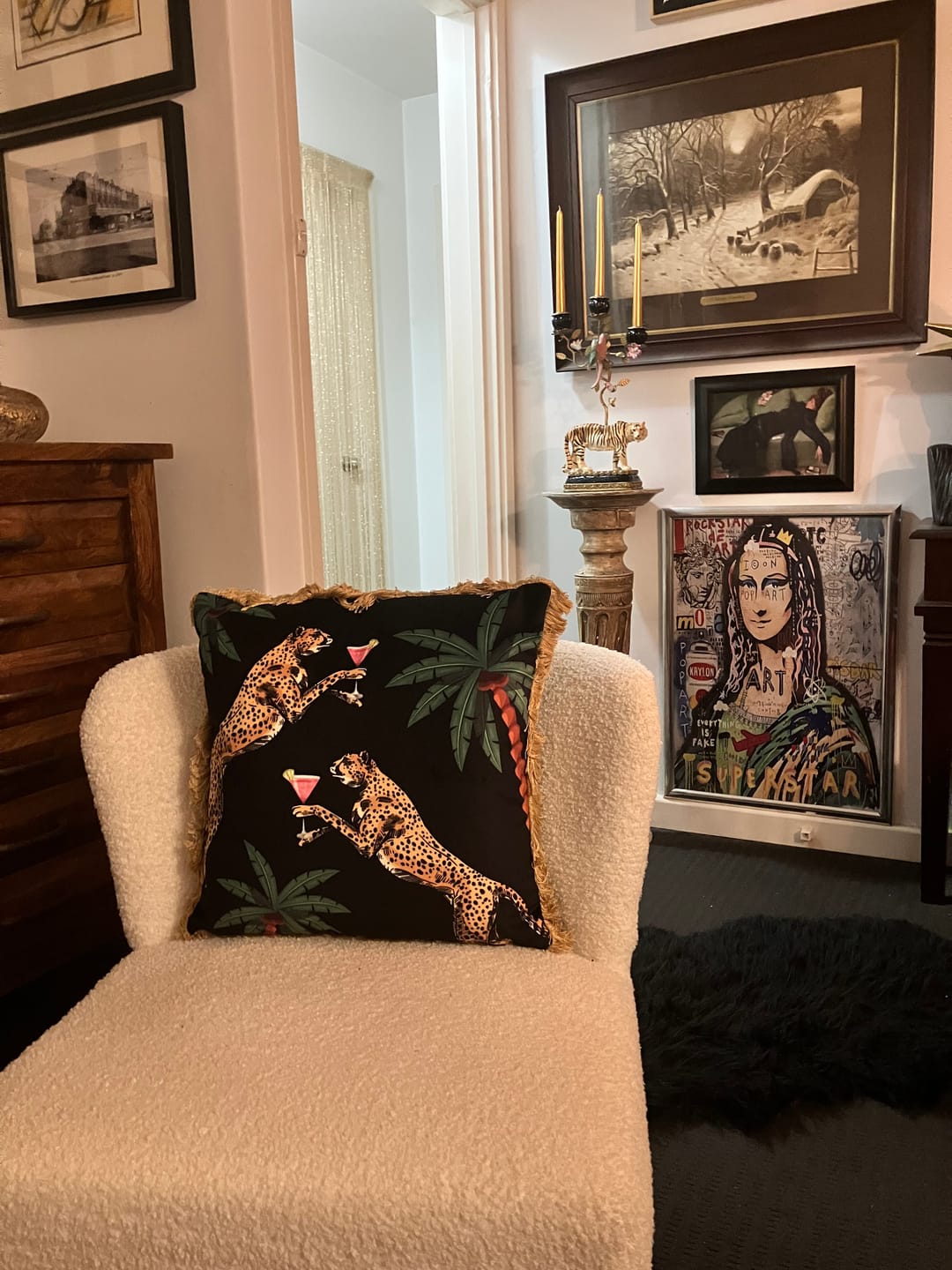 Cocktail Cheetah print decorative cushion by Queen K on cream textured armchair in stylish living room