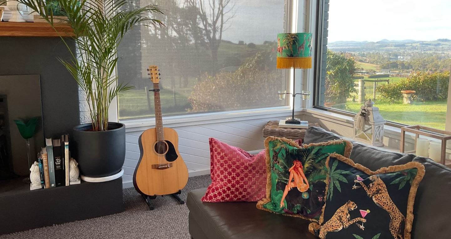 Cocktail Cheetah print decorative cushion from Queen K on a sofa with tropical design and pink cushion