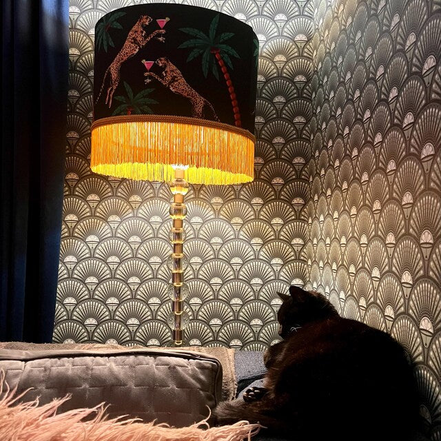 Cocktail Cheetah Tassel Drum Lampshade Black with leopard print and yellow fringe on a table lamp