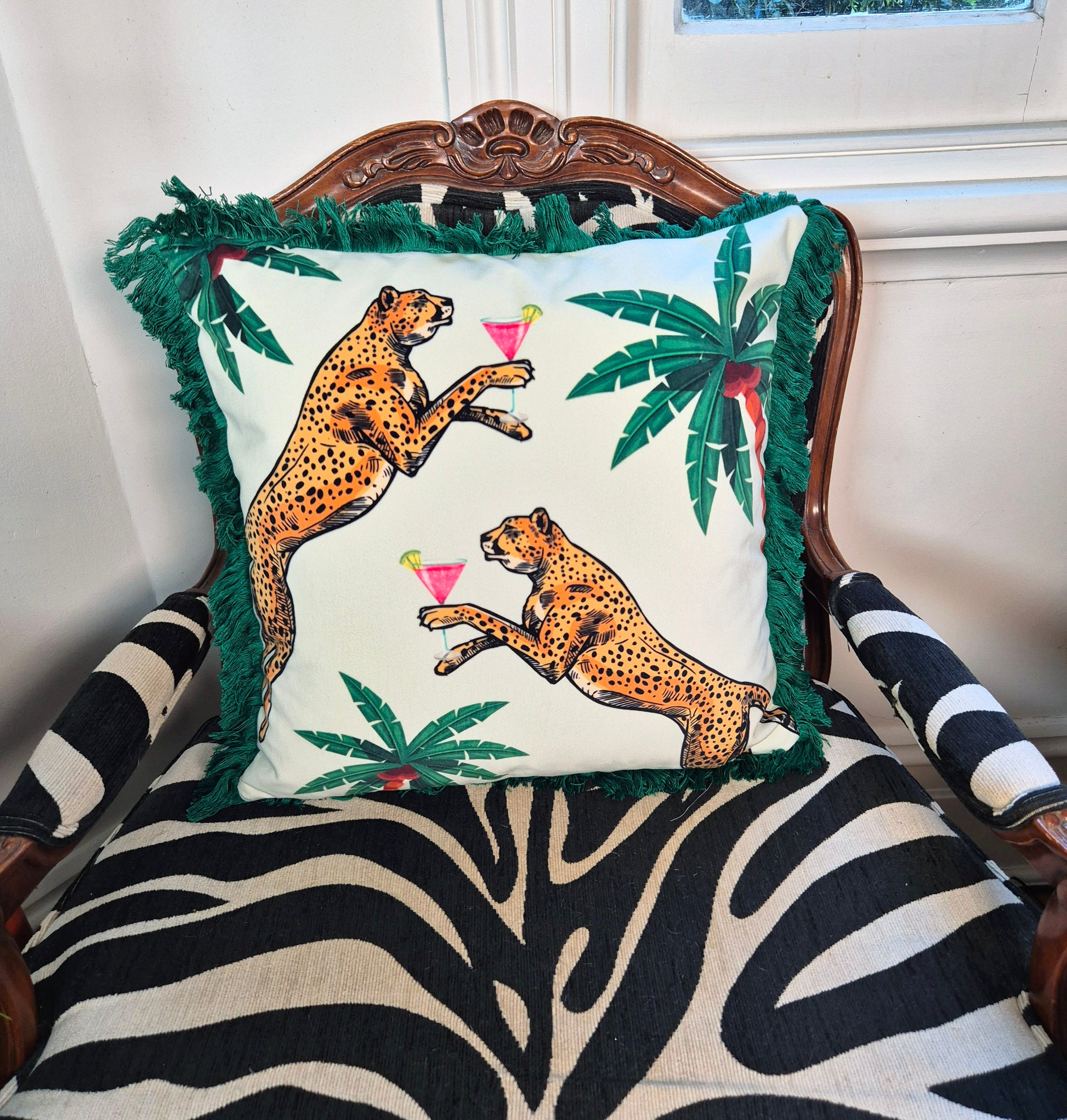 Queen K Cocktail Cheetah Velvet Cushion Ice Dream with green fringe and cheetah print holding cocktails