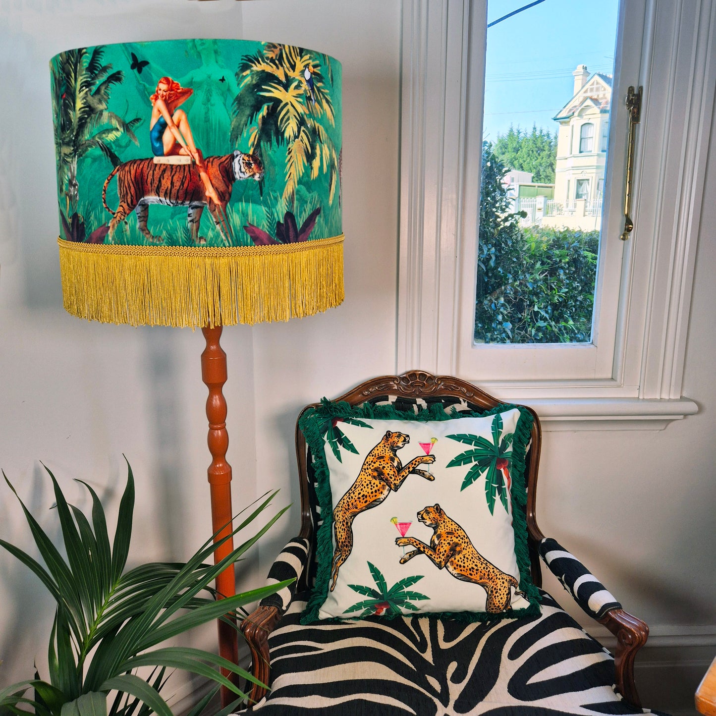 Cocktail Cheetah Velvet Cushion Ice Dream with two cheetahs holding cocktails on tropical leaf background in a zebra print chair