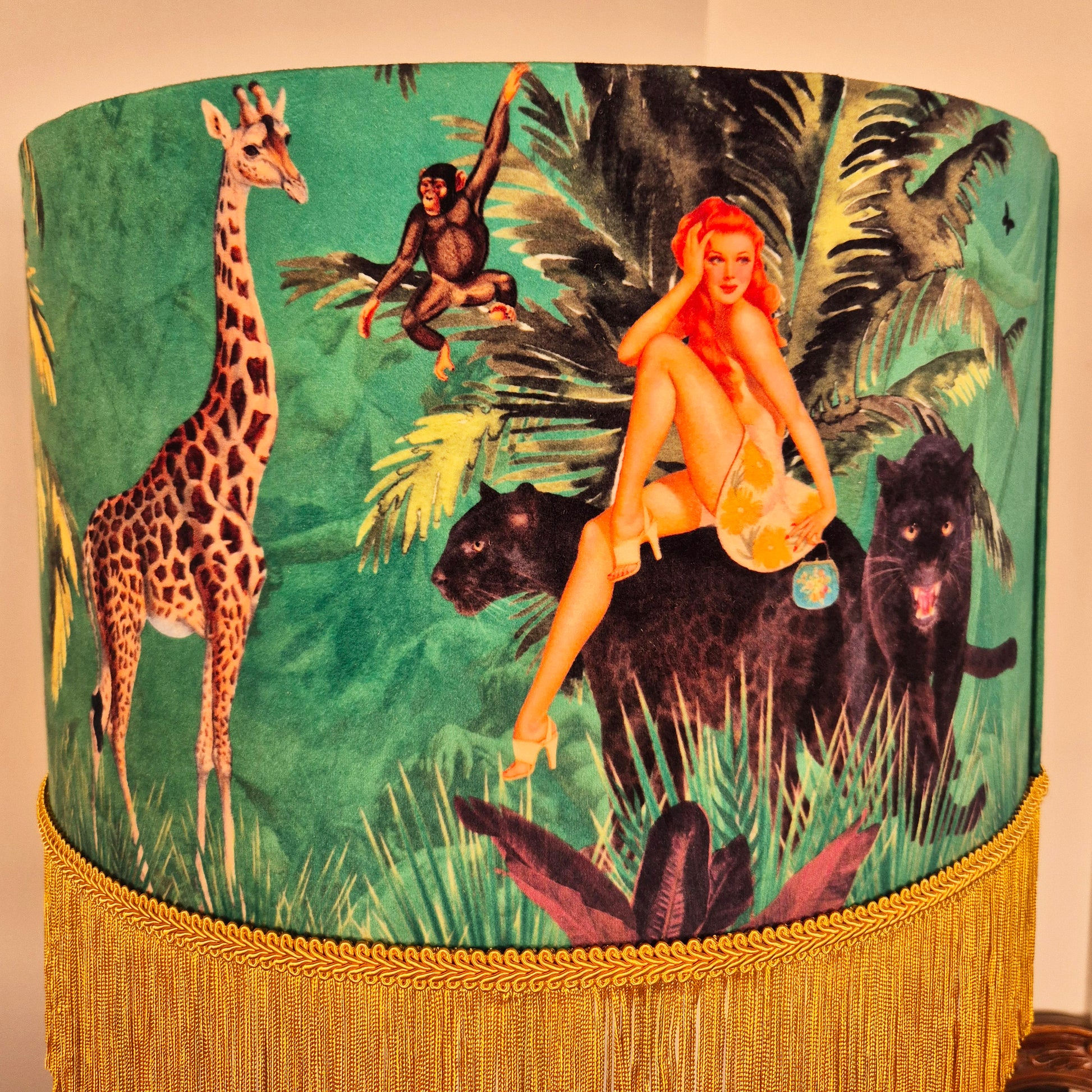 Jungle Walk Green Tassel Fringed Drum Lampshade featuring a jungle scene with animals and a woman