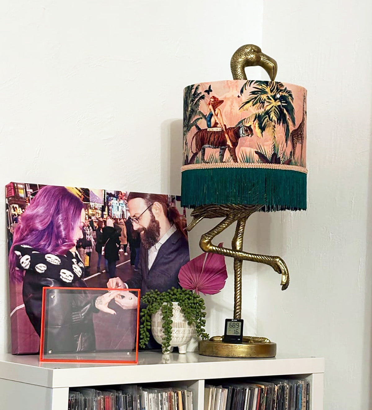 Queen K Jungle Walk Pink Fringed Drum Lampshade with tropical design and green fringe on flamingo base lamp