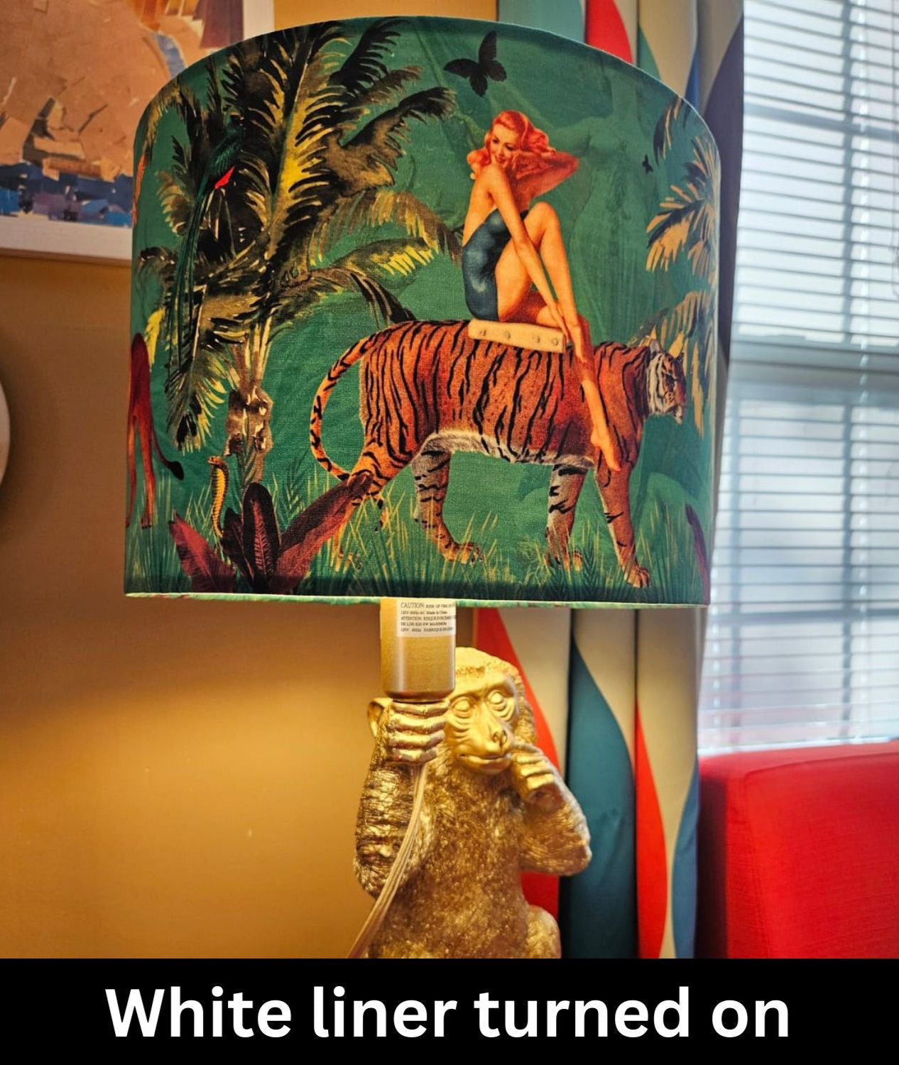Jungle Walk Pink Fringed Drum Lampshade with vintage jungle artwork featuring a tiger and woman on a lamp