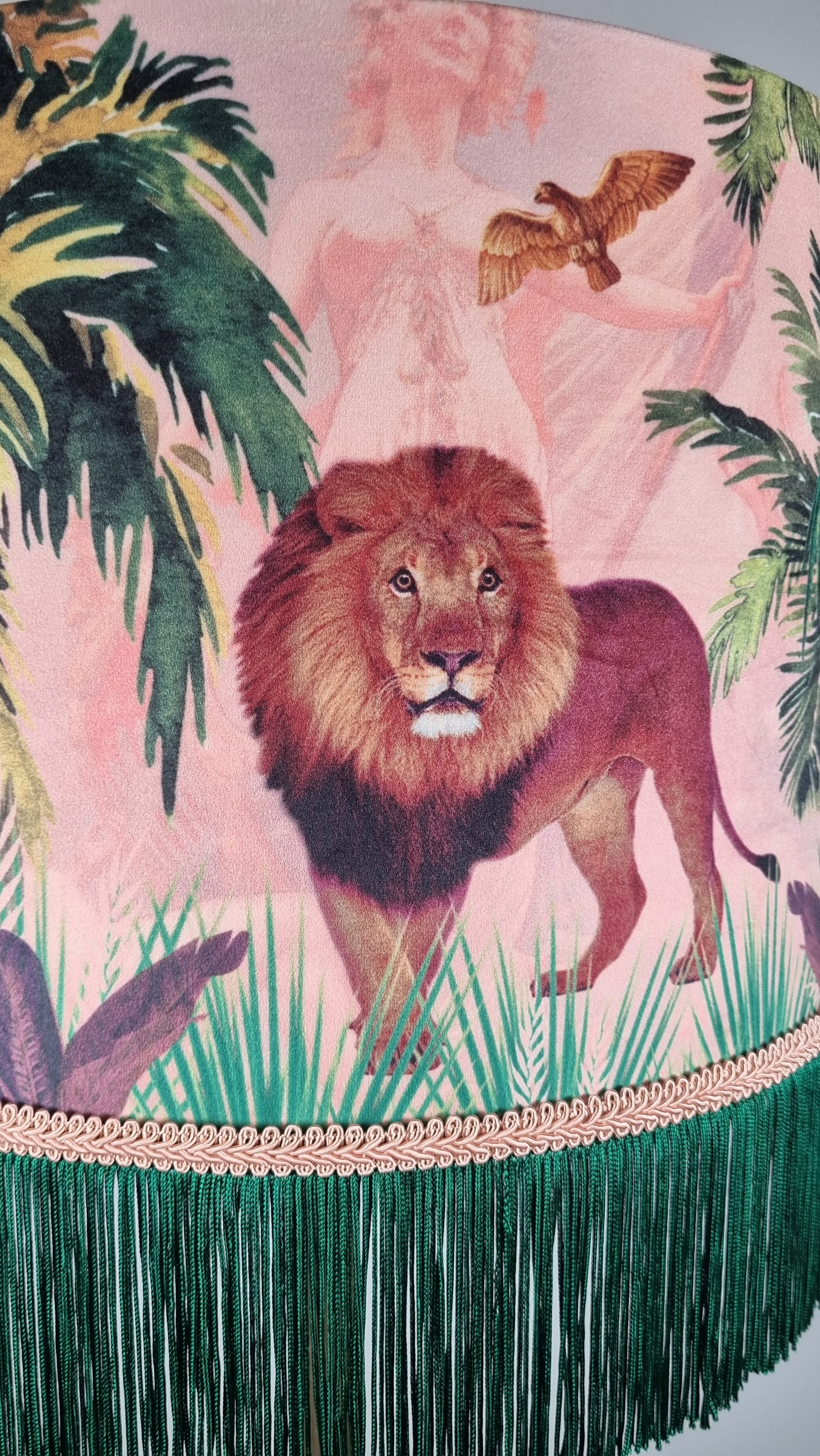Queen K Jungle Walk Pink Fringed Drum Lampshade featuring a lion and tropical jungle design with green fringe trim