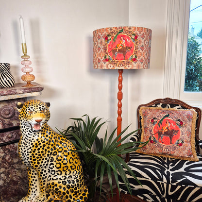 Alice Vintage Drum Lampshade by Queen K with red patterned design on wooden floor lamp