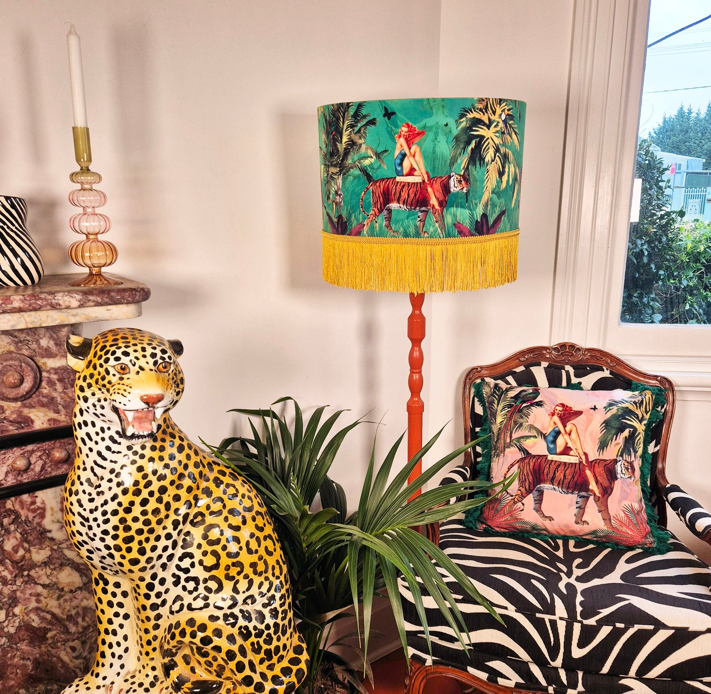 Queen K handmade jungle print cushion with tiger and tropical design on zebra-patterned chair